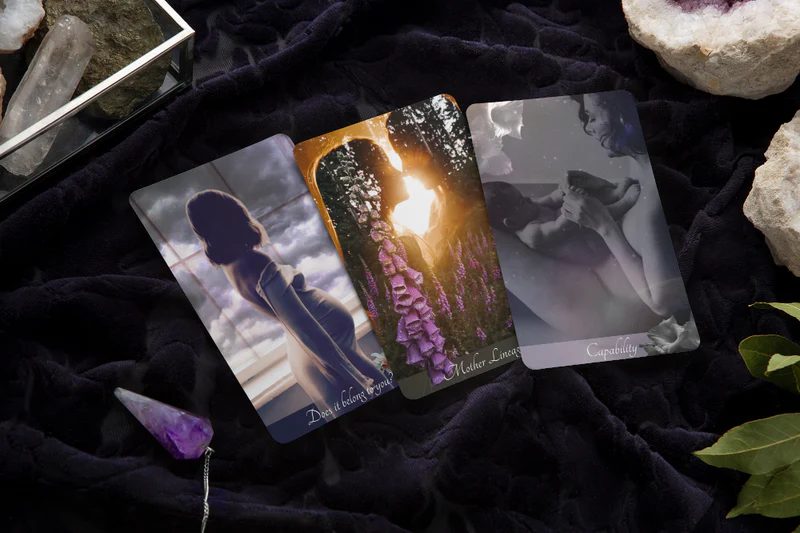 The Cosmic Mother oracle deck — cards fanned out, showing the artwork up close